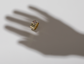 ILA SODHANI Aubergine Ring with lilac natural spinel stone set into wide yellow gold band; shown being worn by shadow hand on white background.