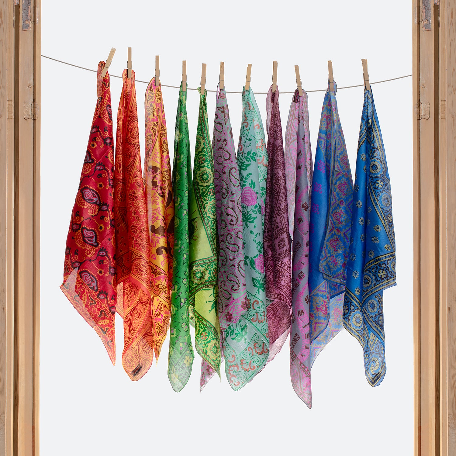 ILA SODHANI hand printed scarves hanging in a door frame